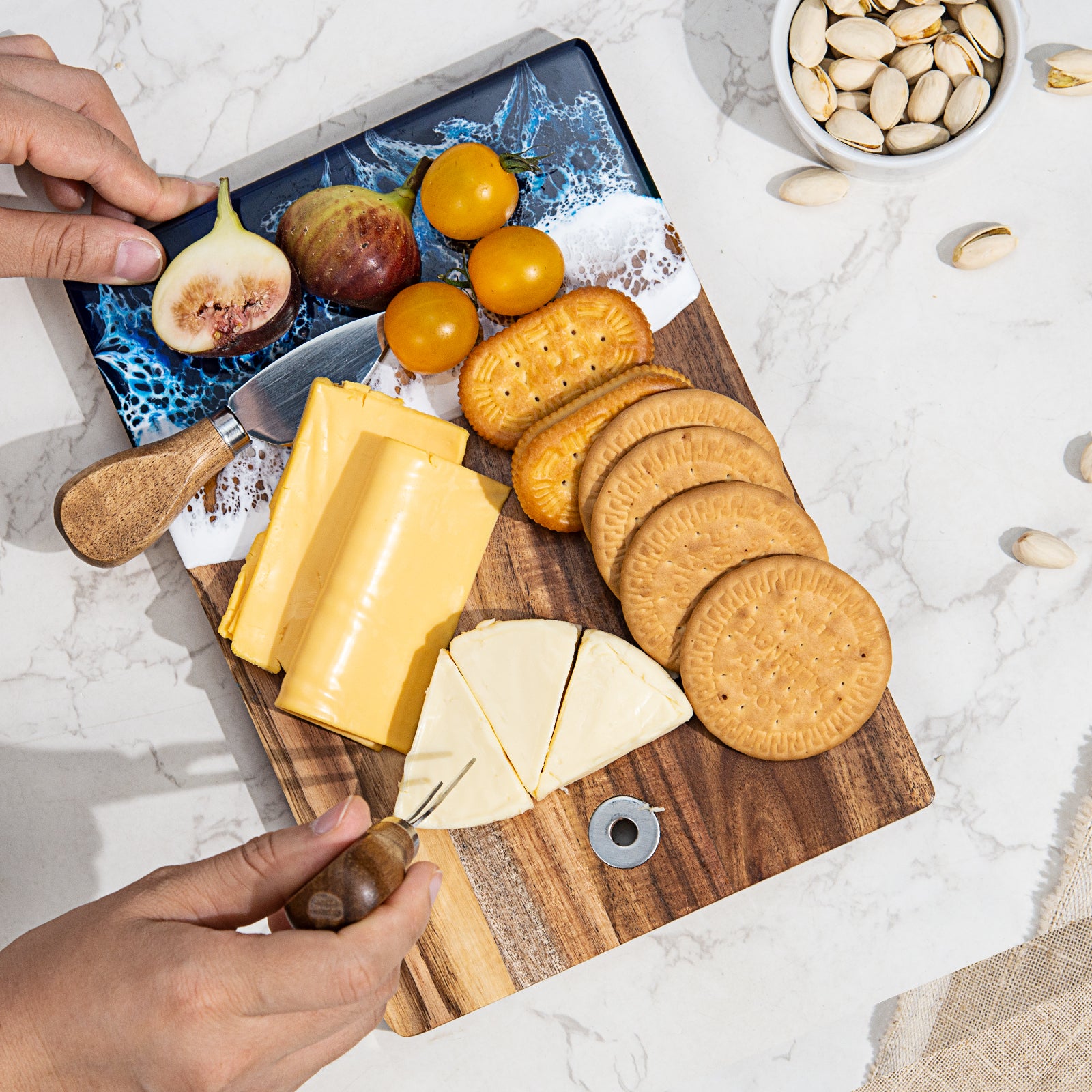 Small acacia wood resin cutting board with mom engraving on kitchen counter